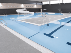 Piscina interior moderna con tobogán blanco y carriles de natación, piscinas municipales.